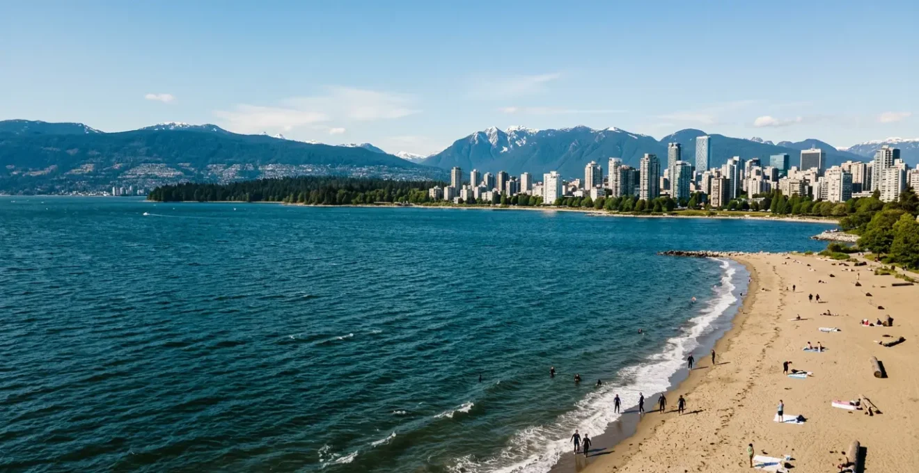 Aerial view of Vancouver's coastline showing the stark contrast between the cold Pacific Ocean and the city skyline in summer