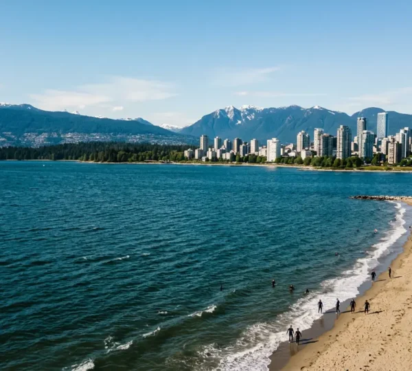 Aerial view of Vancouver's coastline showing the stark contrast between the cold Pacific Ocean and the city skyline in summer