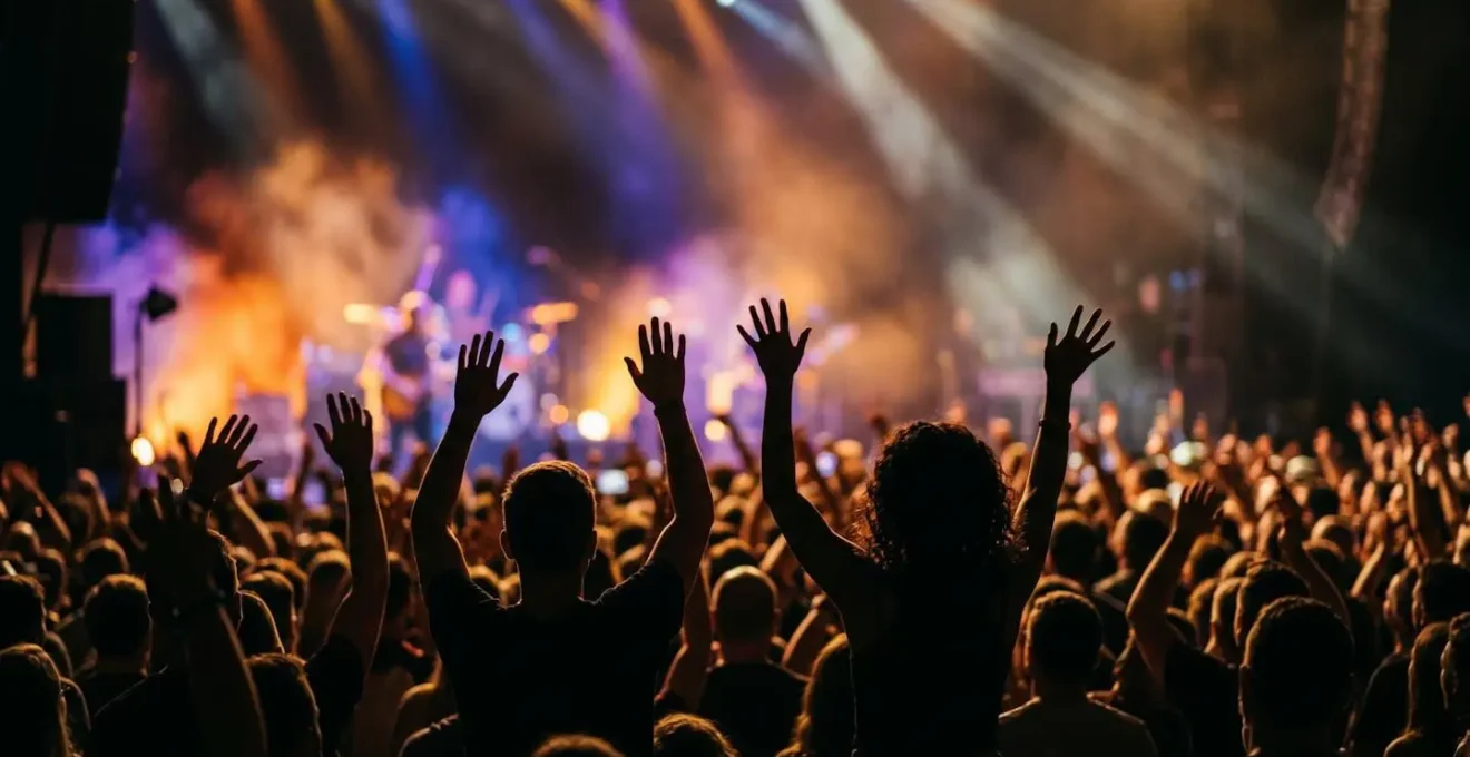 Vibrant concert crowd with raised hands and atmospheric stage lighting at Vancouver music venue