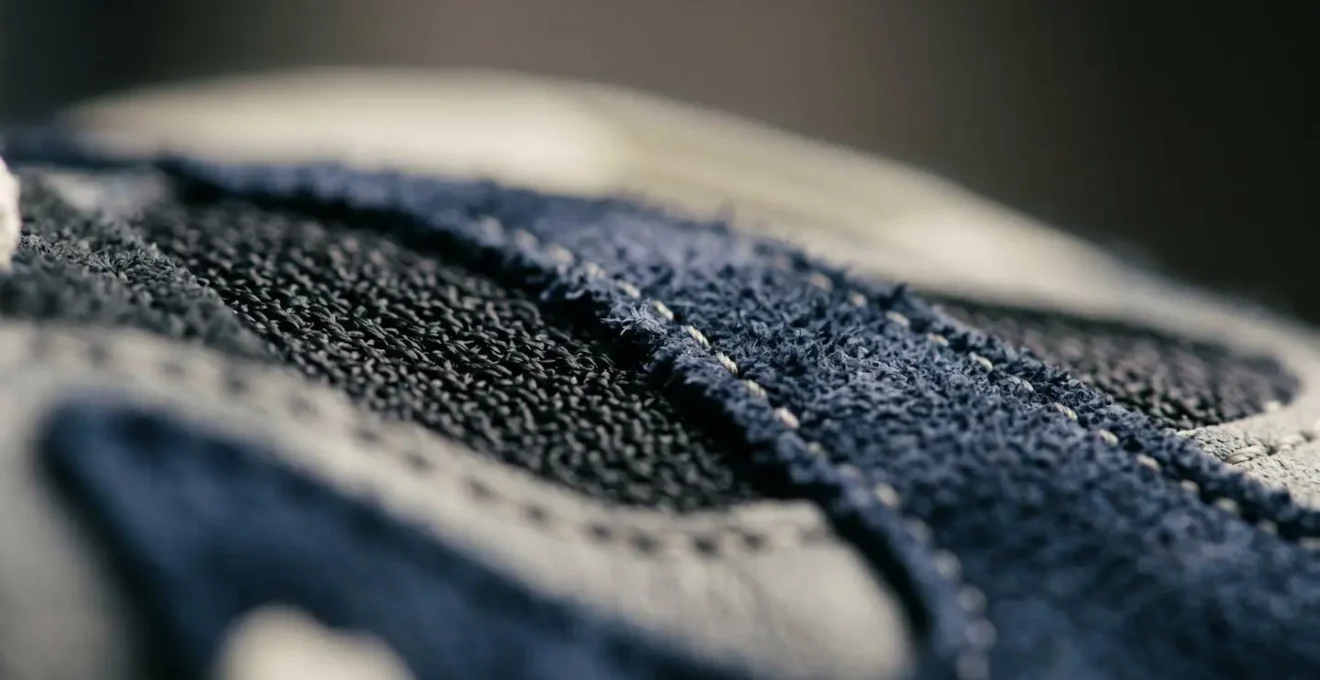 Extreme close-up of premium sneaker material showing intricate textile weave and craftsmanship details