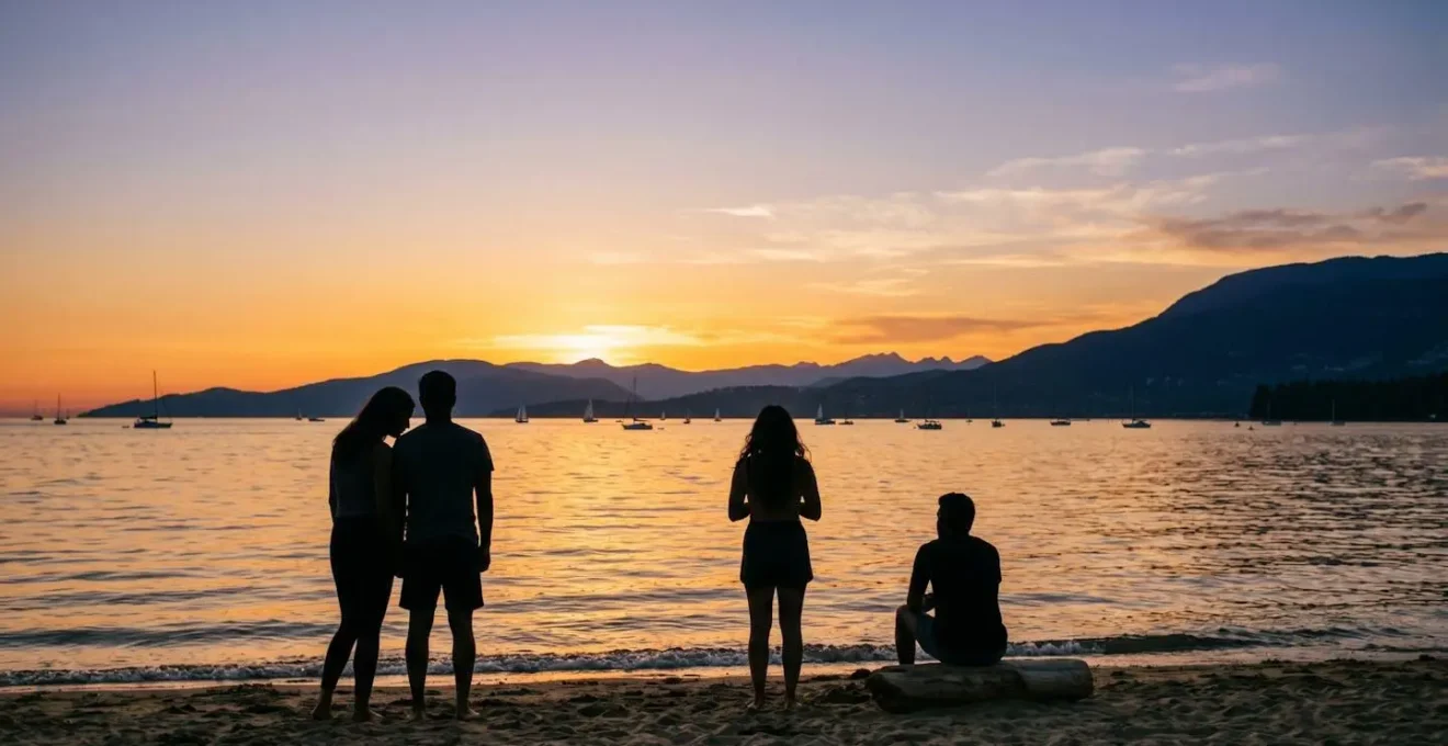 Silhouetted beachgoers watching the golden hour sunset over the Pacific Ocean at a Vancouver beach