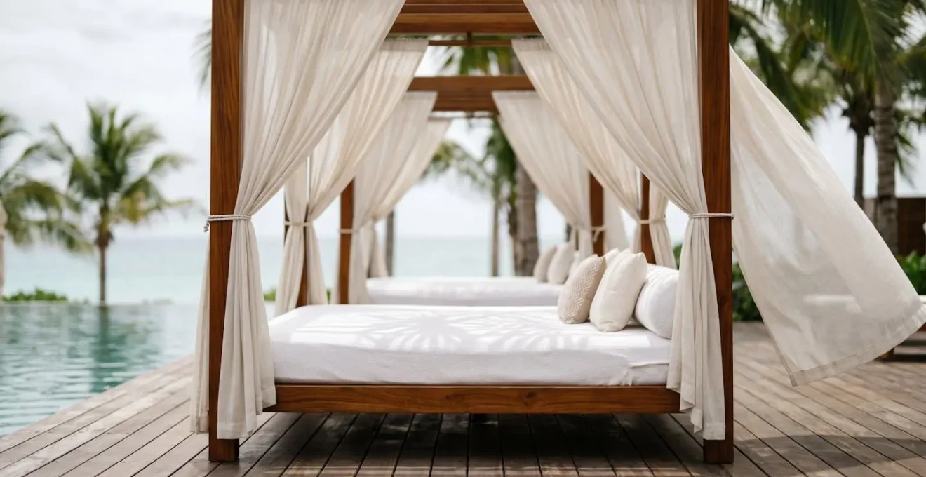 Elegant poolside cabana with flowing curtains beneath palm trees at luxury Vancouver hotel rooftop